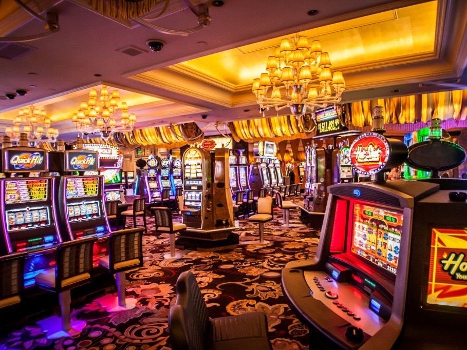 Casino floor with rows of slot machines under chandelier light, illustrating a gaming-platform infrastructure engagement.