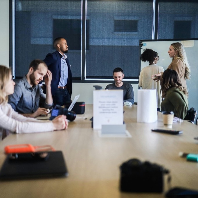 Team meeting in a bright office around a conference table, representing the start of an infrastructure engagement.